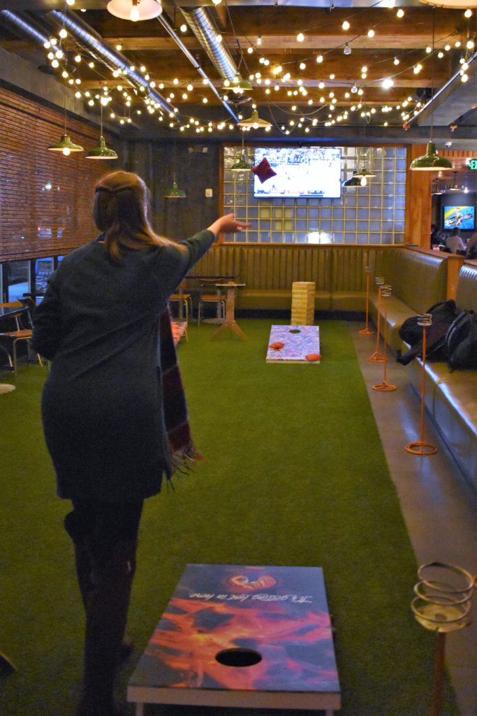 Playing corn hole at Backyard Betty's